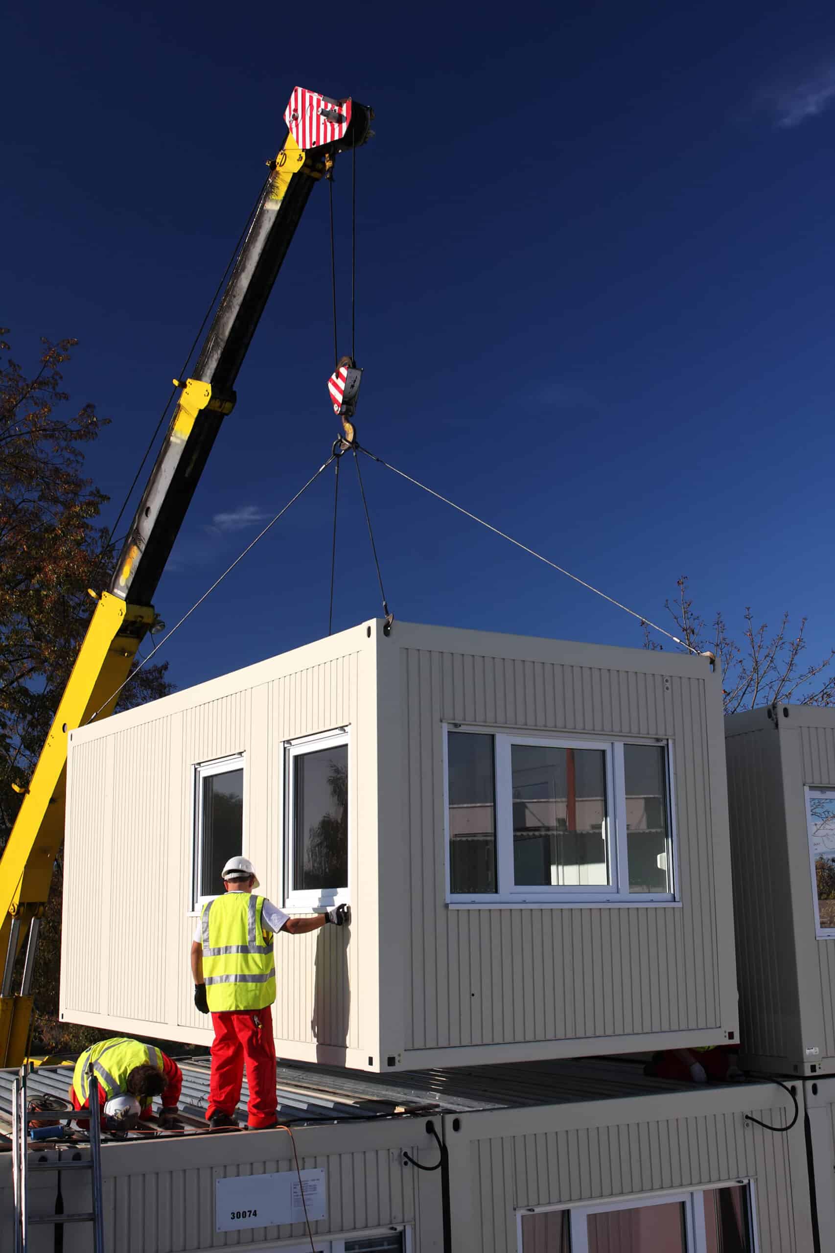 Mobile container home being lifted into place